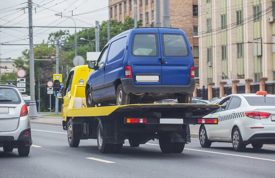 Tow truck transporting a broken car