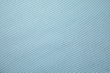 Soft light blue knitted plaid as background, top view