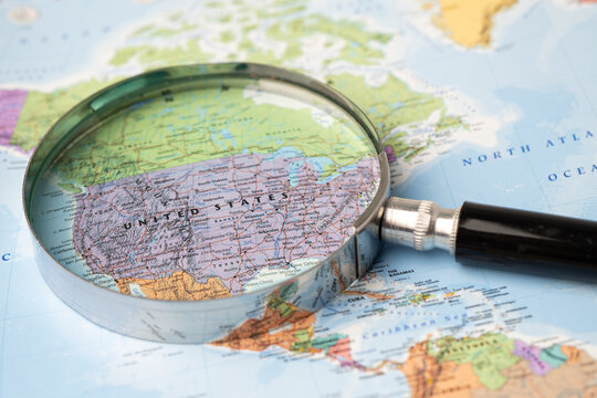 Bangkok, Thailand - November 01, 2020 USA, America, Magnifying glass close up with colorful world map