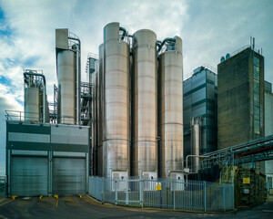 An industrial site with gleaming silver towers and pipework