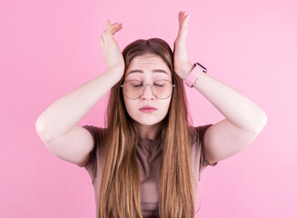 Fototapeta na wymiar Young woman with a headache holds her temples with her hands. Health, migraine and headache concept.