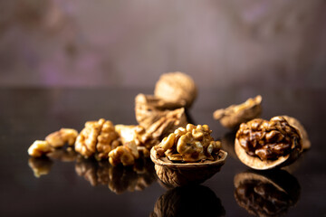 Nuts, details of nuts scattered on a black reflective surface, abstract background, selective focus.