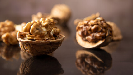 Nuts, details of nuts scattered on a black reflective surface, abstract background, selective focus.