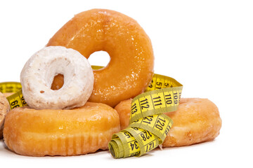 donuts and cakes with measuring tape isolated on white