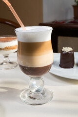 Coffee glass on a table with desserts