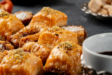 Assortment of turkish baklava on black textured surface