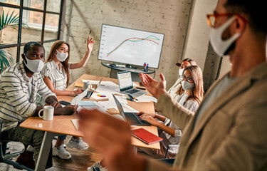 Diverse business worker discuss and meeting while Wearing Medical Mask as protection from corona virus. New normal office working. Group of multiethnic people in business reopen. flu prevent healthy