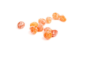 Candied kumquats, heap of dried fruits isolated on white background