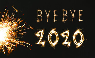 Bye Bye 2020. Bright text and sparkler on black background