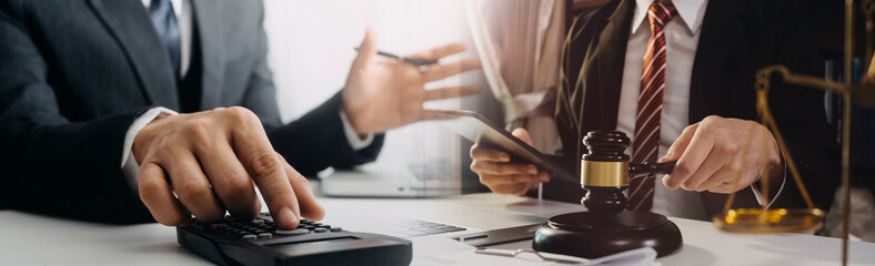 Business and lawyers discussing contract papers with brass scale on desk in office. Law, legal services, advice, justice and law concept picture with film grain effect
