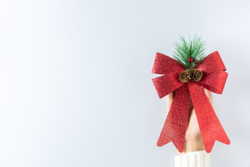 Luxury red ribbon in young women hand. - Christmas gift concept.
