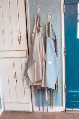 Colorful striped aprons hang on the wall inside the workshop.