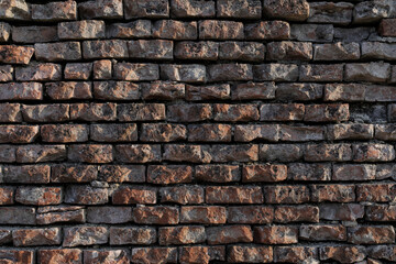 Rustic brick wall with sunlight and shadows, rough and urban wall for a banner, background or texture, no person
