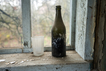 Old dusty soviet bottle in abandoned village of Chernobyl zone