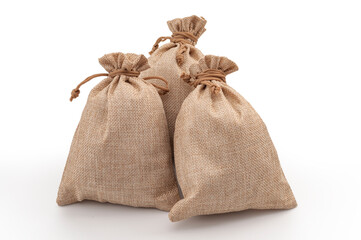 Agricultural hessian cloth sacks, rough sack material and linen fabric textile concept with pile of three brown burlap or sackcloth bags isolated on white background with clipping path cutout