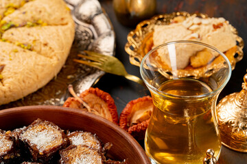 Glass cup of tes and turkish desserts on table