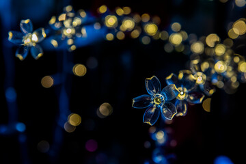 .Flower-shaped Christmas lights with blurred lights in the background