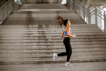 Young woman running in the urban environment
