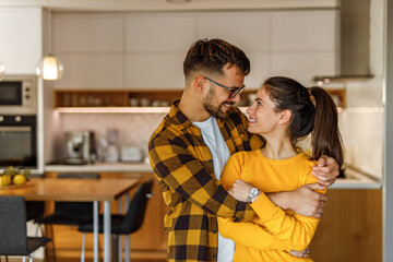 Happy faces, kitchen in the background.