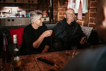 Husband and wife drinking a rakija, an alcoholic Serbian drink, together.