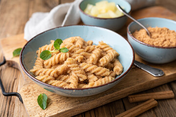 Fusilli pasta with sweet roasted semolina and cinnamon, served with pineapple pieces