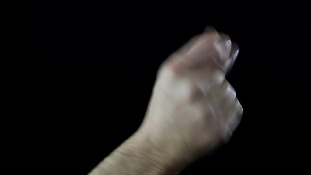 Close up, hand of man on black background while snapping his fingers