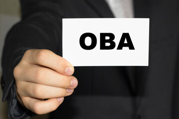 Card with text OBA on hand. You can use in business, marketing and other concepts. Messege of the day.