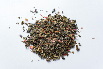 green tea with petals on white background