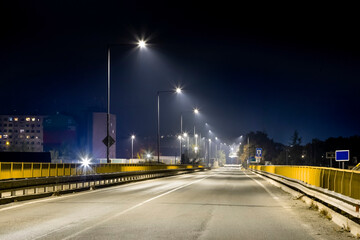 entrance to city, road bridge with modern LED illuminated at night
