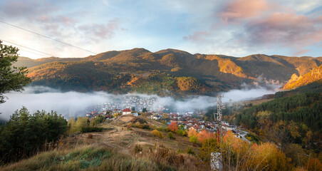 Devin, Bulgaria. Early morning view to the small city with fog at autumn. Surrounded by mountains