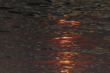 orange sunset on the sea, the setting sun is reflected in the water.