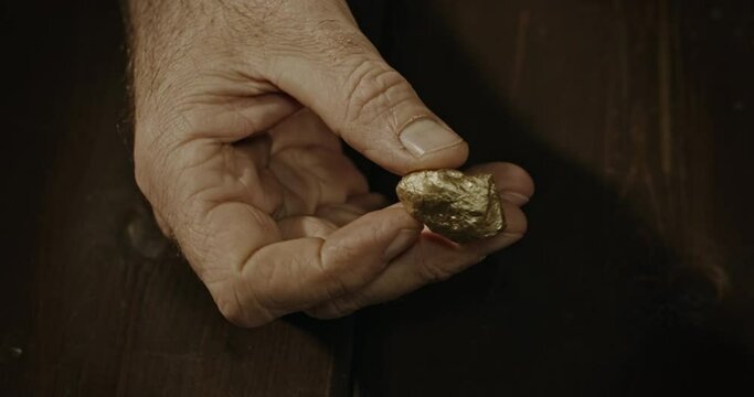 Hand holding gold nugget