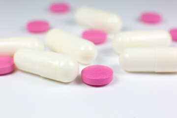 Colored pills on white background. Close up. Medical treatment concept.