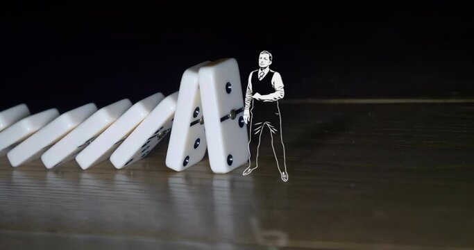 A drawn businessman stops white dominoes falling on wooden background.