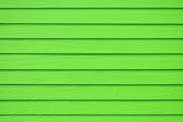 Wall panel paint green color synthetic wooden plank texture surface background.Outdoor panel engineered wood nature pattern or abstract backdrop vintage  horizontal lines,summer design and decoration.