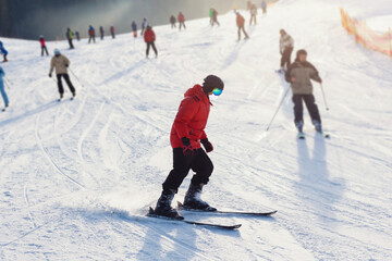 Coronavirus in winter. Skiing with face mask. winter vacation in pandemia. Portrait of caucasian young man with face mask. Winter is coming in new reality.