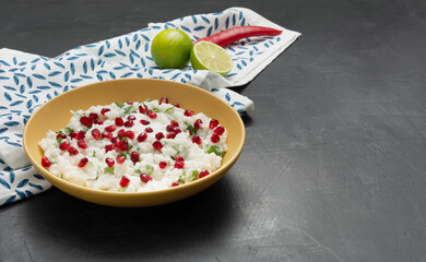 Curd cheese in a yellow plate on a dark background.
