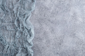 Gauze tablecloth on concrete background. Top view, with copy space