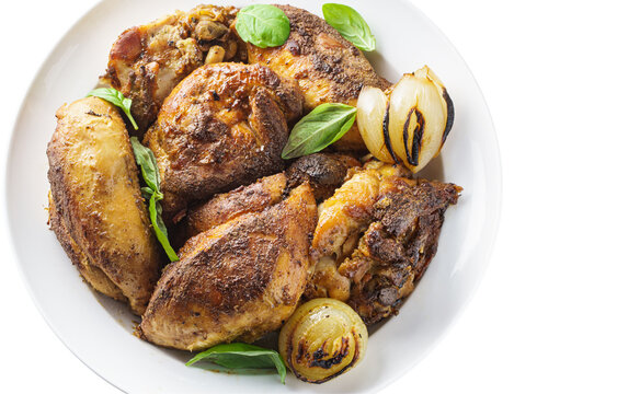 Sliced rostaed chicken on plate, top view on white