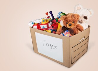 Toys collection in card box on pastel background