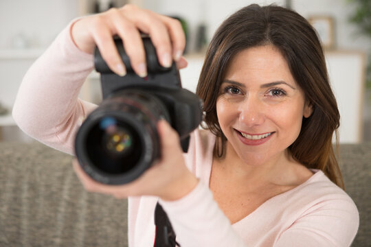 woman holding a dslr camera