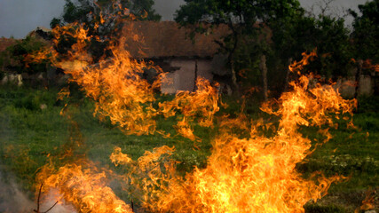 Fire outside a house in a rural village