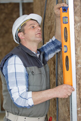 man using a spirit level on the wall
