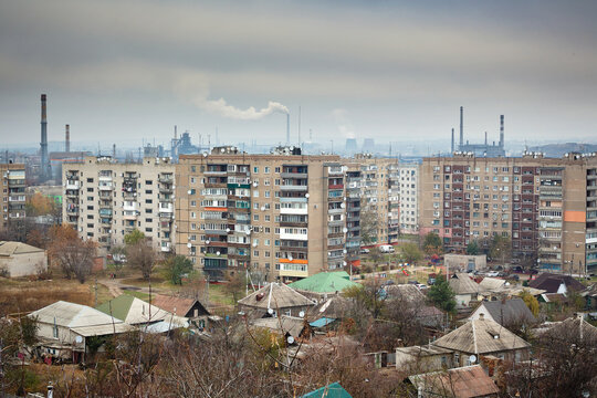 Industrial city. Residential buildings on the background of smoky chimneys of factories. Ecology.