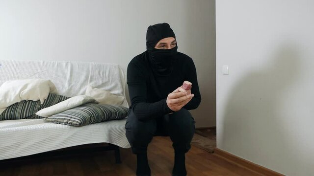 Burglary and entry with the intent to commit a crime. A masked thief sneaks into the apartment and tries to coax a German shepherd with sausage.intrusion of a burglar in a house inhabited