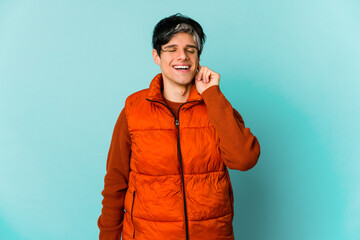 Young caucasian skinny man expressing emotions isolated on blue background
