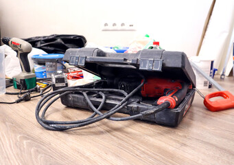 Construction tools for repairs in the apartment are on the floor, side view-the concept of repair work in the house yourself