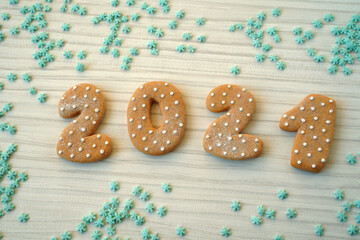  Ginger bread cookies on wooden table. Merry Christmas and Happy New Year 2021!