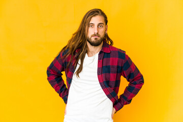 Young man with long hair look sad, serious face, feeling miserable and displeased.