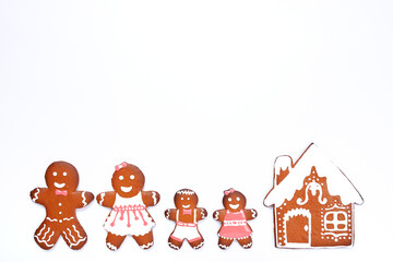 The hand-made eatable gingerbread house, little men on white background